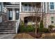 Inviting townhome entryway with brick stairs and manicured landscaping at 322 Clementine Dr, Cary, NC 27519