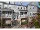Lovely townhome featuring a covered porch and well-manicured landscaping at 322 Clementine Dr, Cary, NC 27519