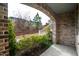 Charming brick front porch displaying landscaped bushes and a view of the street at 322 Clementine Dr, Cary, NC 27519