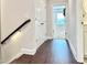 Hallway with wooden floors and a white closet, leading to a bedroom with a wreath on the door at 322 Clementine Dr, Cary, NC 27519