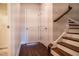Hallway featuring wood flooring, a staircase, and a white door at 322 Clementine Dr, Cary, NC 27519
