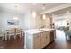 Bright kitchen and dining area with stainless steel appliances, light wood table, and modern decor at 322 Clementine Dr, Cary, NC 27519