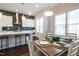 Bright eat-in kitchen features stainless steel appliances, a large window, and an inviting dining area at 322 Clementine Dr, Cary, NC 27519
