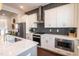 Modern kitchen featuring quartz counters, stainless appliances, and sleek white cabinetry at 322 Clementine Dr, Cary, NC 27519