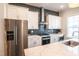 Well-equipped kitchen featuring stainless steel appliances, white cabinets, and quartz countertops at 322 Clementine Dr, Cary, NC 27519