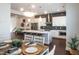 Stylish kitchen features a herringbone backsplash, stainless steel appliances, island seating, and a dining table at 322 Clementine Dr, Cary, NC 27519