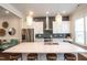Open kitchen design with large island, stainless steel appliances, and modern light fixtures at 322 Clementine Dr, Cary, NC 27519