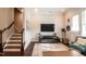 Cozy living area with staircase, TV, and accent rug at 322 Clementine Dr, Cary, NC 27519