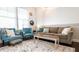 Bright living room featuring natural light, accent chairs, and a comfortable sofa at 322 Clementine Dr, Cary, NC 27519