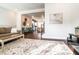 Open living room with hardwood floors, bright lighting, and comfortable seating, showcasing an open floor plan at 322 Clementine Dr, Cary, NC 27519