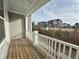 Outdoor porch view with a white railing and view of nearby building and landscaping at 322 Clementine Dr, Cary, NC 27519