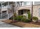Brick-accented townhome features well-maintained landscaping and inviting entrance at 322 Clementine Dr, Cary, NC 27519