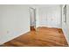 Hardwood flooring in a bright bedroom showcasing three doors and a window at 3622 Colchester St # 13, Durham, NC 27707
