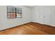 Bedroom featuring hardwood floors, bright window, and a closet with white door at 3622 Colchester St # 13, Durham, NC 27707