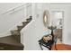 Foyer features hardwood floors, painted stairs, and modern decor with view into bathroom at 3622 Colchester St # 13, Durham, NC 27707