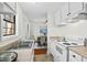Efficient kitchen layout with white cabinetry, a double basin sink, and a view into the adjacent dining area at 3622 Colchester St # 13, Durham, NC 27707