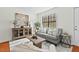 Inviting living room with neutral tones, a modern cabinet, and a bright window at 3622 Colchester St # 13, Durham, NC 27707