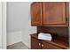 Bathroom storage with wooden cabinets, countertop, and a stack of white towels at 3622 Colchester St # 13, Durham, NC 27707