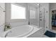 Well-lit bathroom features a soaking tub with a tiled shower at 40 Long Needle Ct, Youngsville, NC 27596
