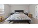 Bright primary bedroom features a large bed, two nightstands, and wood-look flooring at 40 Long Needle Ct, Youngsville, NC 27596