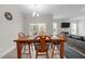 Open dining area features wood table and chairs, chandelier, and access to a screened porch with a grill at 40 Long Needle Ct, Youngsville, NC 27596