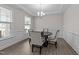 Elegant dining room with a round table, upholstered chairs, modern lighting, and decorative trim at 40 Long Needle Ct, Youngsville, NC 27596