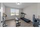 Bright exercise room with light gray flooring, exercise bike, and natural light from the window at 40 Long Needle Ct, Youngsville, NC 27596