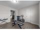 Spacious exercise room featuring an exercise bike, weight rack, and light gray floors at 40 Long Needle Ct, Youngsville, NC 27596