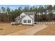 Inviting two-story home showcasing a lovely front porch, and a long driveway at 40 Long Needle Ct, Youngsville, NC 27596