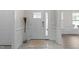 Inviting foyer with tile flooring, wainscoting, a stylish entryway table, and a glimpse into the home at 40 Long Needle Ct, Youngsville, NC 27596