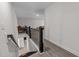 Hallway overlooking the living room with modern railings and light gray flooring at 40 Long Needle Ct, Youngsville, NC 27596