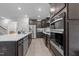 Well-equipped kitchen showcasing stainless steel appliances, a center island, and plenty of cabinet space at 40 Long Needle Ct, Youngsville, NC 27596