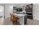 Modern kitchen boasts stainless steel appliances, dark cabinetry, a large island, and stylish wood-look floors at 40 Long Needle Ct, Youngsville, NC 27596