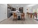 Open kitchen area featuring stainless steel appliances, an island with seating, and an adjacent dining area at 40 Long Needle Ct, Youngsville, NC 27596
