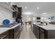 Modern kitchen features stainless steel appliances, stone countertops, and opens into the living and dining area at 40 Long Needle Ct, Youngsville, NC 27596