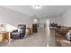 Open living room boasts light gray flooring, comfortable seating, and staircase access at 40 Long Needle Ct, Youngsville, NC 27596