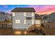 View of the home's rear exterior featuring a cozy deck with wooden stairs and a private yard at 40 Long Needle Ct, Youngsville, NC 27596