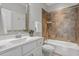 Bathroom features a vanity with marble countertop, with a tiled shower and bathtub combo at 4009 Banks Stone Dr, Raleigh, NC 27603
