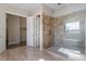 Walk-in shower with glass door and tile surround at 4009 Banks Stone Dr, Raleigh, NC 27603