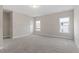 Neutral bedroom with carpet flooring, two windows providing natural light, and a closet at 4009 Banks Stone Dr, Raleigh, NC 27603