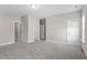 Spacious bedroom with neutral carpet and paint features a walk-in closet and natural light at 4009 Banks Stone Dr, Raleigh, NC 27603
