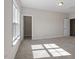 Sunlit bedroom boasts neutral carpet and walls, a large window, and convenient closet access at 4009 Banks Stone Dr, Raleigh, NC 27603