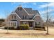 Traditional brick home featuring dormers, black shutters, and a well-manicured yard on a bright day at 4009 Banks Stone Dr, Raleigh, NC 27603