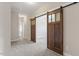 Hallway with carpeted floors and wooden sliding door at 4009 Banks Stone Dr, Raleigh, NC 27603