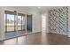 Bright living room with sliding glass doors leading to deck and accent wallpaper at 4009 Banks Stone Dr, Raleigh, NC 27603