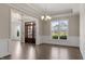Formal living room featuring hardwood floors, decorative trim and lighting, and a large front window at 4009 Banks Stone Dr, Raleigh, NC 27603