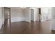 Open-concept living room showcases hardwood floors, decorative trim and lighting, and adjoins the foyer at 4009 Banks Stone Dr, Raleigh, NC 27603
