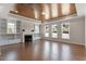 Bright living room boasts a striking wood plank ceiling, fireplace, built-ins and floods of natural light at 4009 Banks Stone Dr, Raleigh, NC 27603