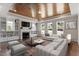 Bright living room boasts a striking wood plank ceiling, fireplace, built-ins and floods of natural light at 4009 Banks Stone Dr, Raleigh, NC 27603