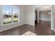 Bright living room with hardwood floors and a large window overlooking the manicured front lawn at 4009 Banks Stone Dr, Raleigh, NC 27603